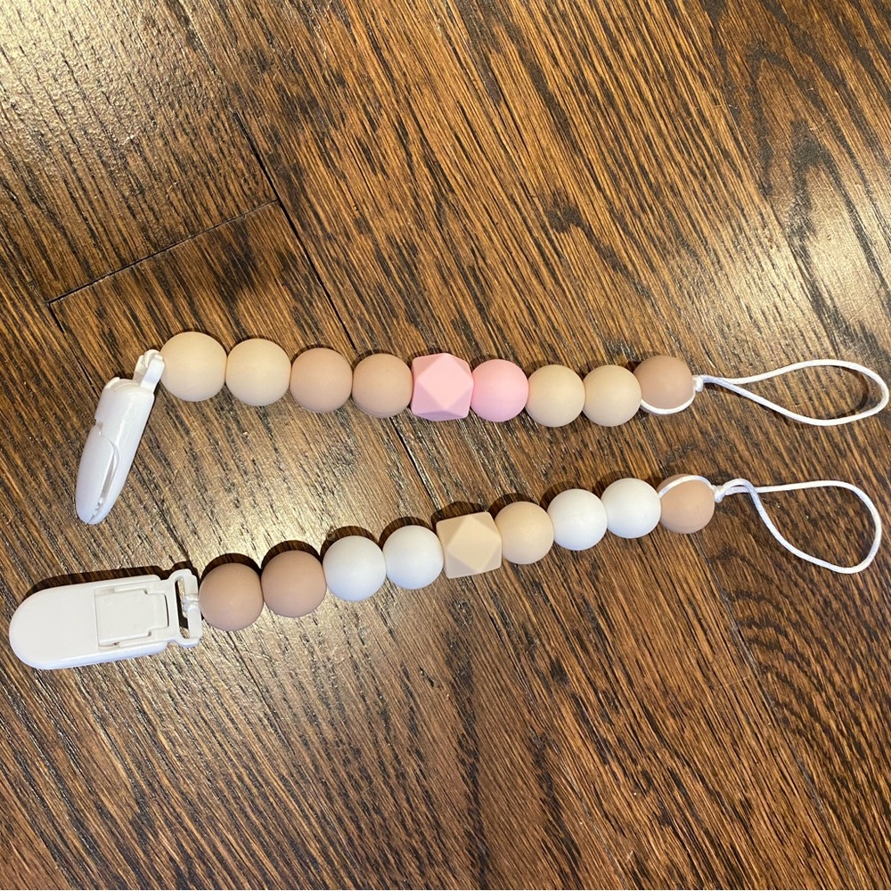 Two silicone pacifier holders, used once